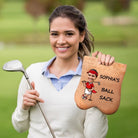 Woman holding personalized golf ball sack with custom cartoon face design