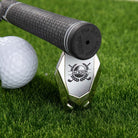 Personalized Jackson golf divot repair tool with magnetic ball marker beside golf club grip