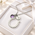 Silver horseshoe charm necklace with engraved initial and birthstone