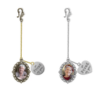 Two graduation hat tassel ornamentations with ornate frames and chains. Each frame holds a photo of an older woman and a small charm inscribed with "so PROUD of you."