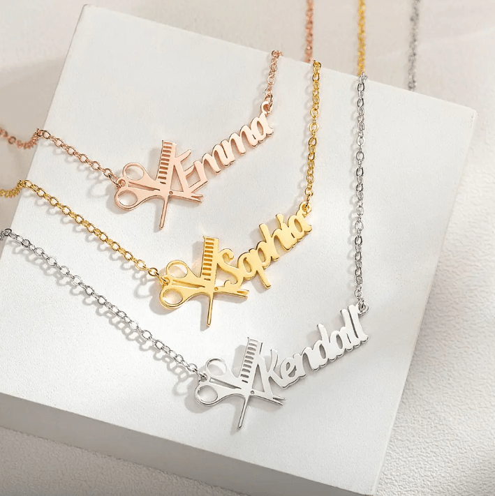 Three personalized hairdresser necklaces with names Emma, Sophia, and Kendall, featuring scissors and comb design in rose gold, gold, and silver finishes.