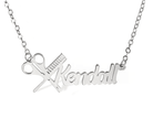 Silver personalized hairdresser necklace with the name Kendall, featuring a scissors and comb design, displayed on a white background.