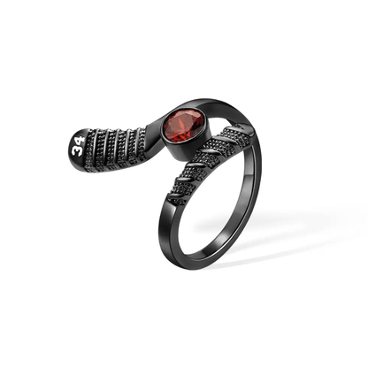 Black hockey stick-shaped ring with red birthstone and '34' engraved, a unique accessory for sports jewelry collectors.