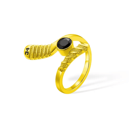 Golden hockey stick-shaped ring with a central black gemstone and '34' engraved, an elegant accessory for hockey fans.