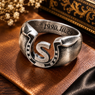 Personalized horseshoe ring with custom S initial and engraved date on vintage leather