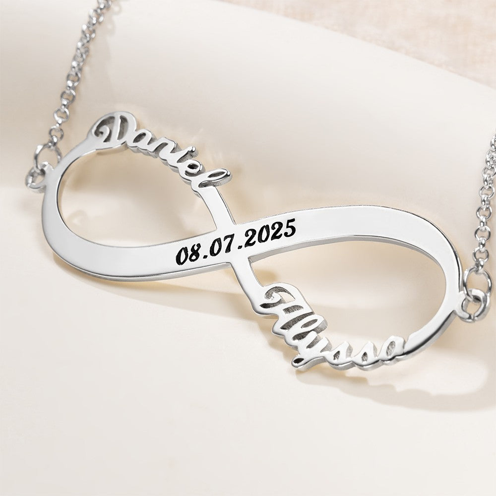 Close-up of custom silver infinity necklace with names and engraved date