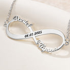 Close-up of custom silver infinity necklace with names and engraved date