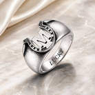 Custom initial horseshoe ring with LUCKY inner engraving on elegant marble background