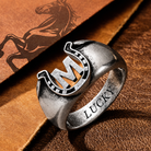 Custom M initial horseshoe ring with LUCKY engraving on clean white background