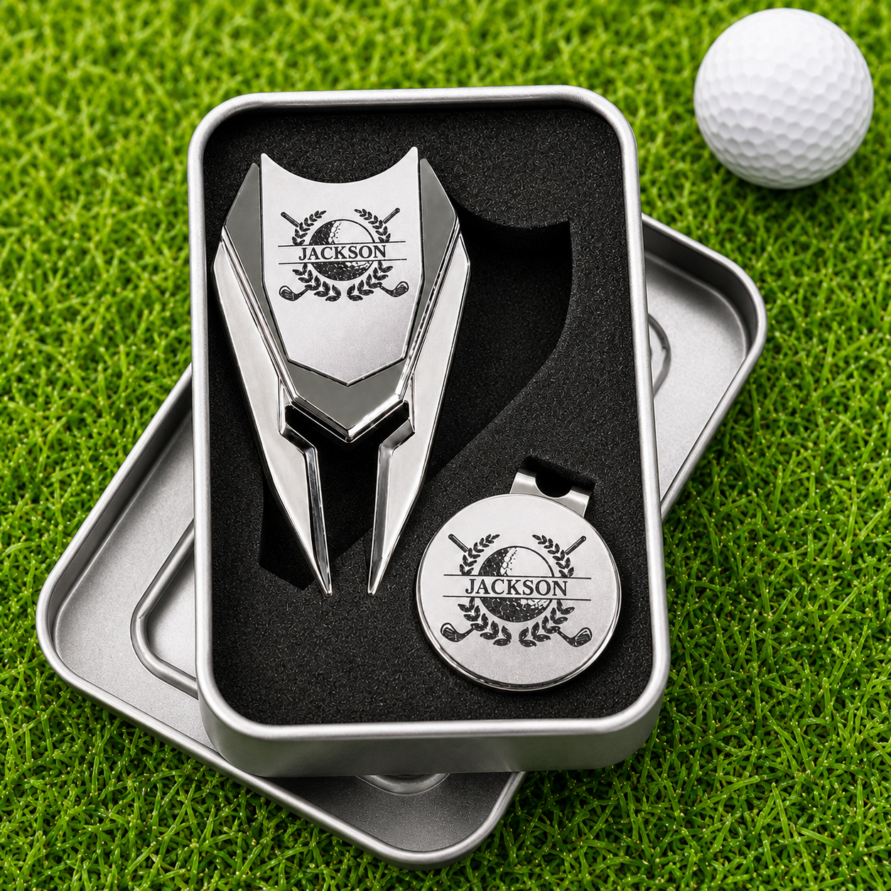 Personalized magnetic golf divot repair tool with removable ball marker in gift tin on green grass