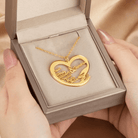 A heart-shaped gold necklace pendant with the names "Wendy, William, Crystal, Sandra, Bella" engraved, presented in a gray jewelry box held by hands.