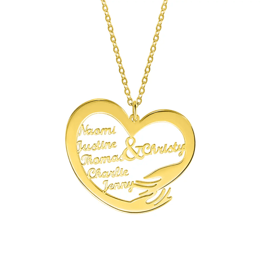 A heart-shaped gold necklace pendant engraved with the names "Naomi, Justine, Thomas, Christy, Charlie, Jenny," on a plain white background.