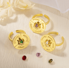 Three gold spinner rings with engraved names and colorful birthstones, perfect for personalized decision-making and as unique, customizable gifts.