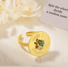 Gold spinner ring with engraved names and a central green birthstone, ideal for making fun decisions and as a unique, customizable gift.