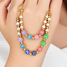 Colorful personalized name necklace with enamel letter beads and gold heart details