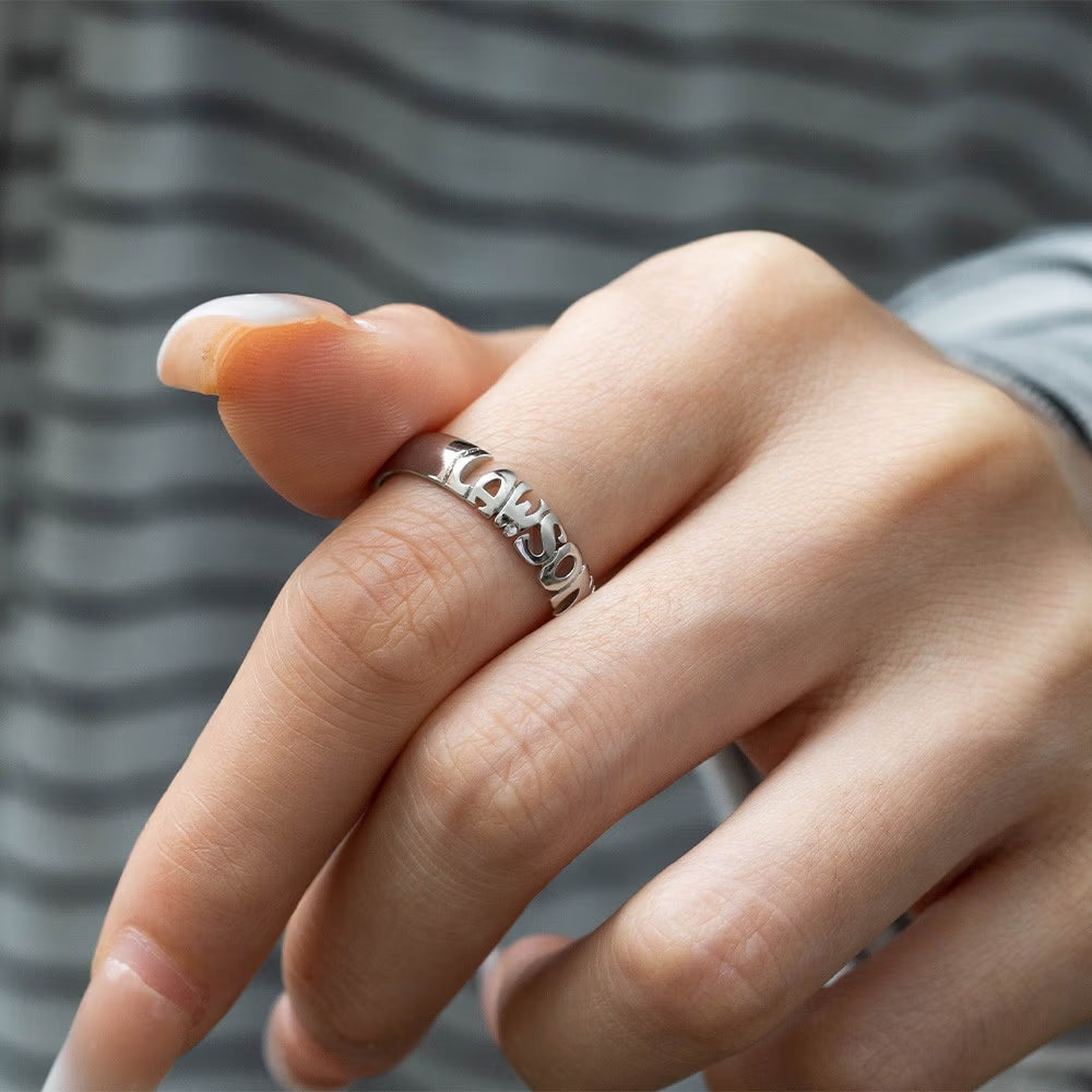 Woman wearing two custom name rings crafted from sterling silver 925