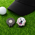 Personalized pet photo golf ball marker with magnetic hat clip beside black golf cap and white golf ball