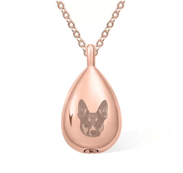 Rose gold teardrop pendant with an engraved image of a dog's face, hanging on a sturdy chain.