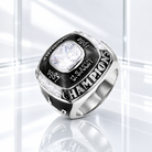 Personalized silver World Champion ring with black enamel, clear center stone, custom year and name engraving on a white glass background.