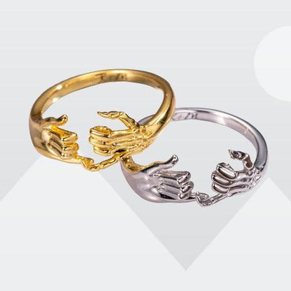 Gold and silver personalized skeleton hand and pinky promise rings, custom engraved, symbolizing unique style and commitment for couples and friends.