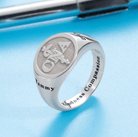 Silver ring with an engraved medical symbol (CNA) and the name "Tammy." The inside of the band is inscribed with the phrase "Kindness Compassion."