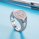 Silver ring with an engraved medical symbol (EMS) and the year "2017." The inside of the band is inscribed with the phrase "Healing hands."