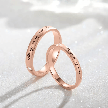 Two intertwined rose gold rings with 'Always on my mind' and 'Forever in my heart' inscriptions and diamonds.