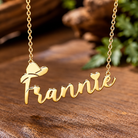 Gold personalized name necklace with cowboy hat and heart on rustic Western background