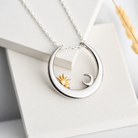 Sun and moon magic ring keeper necklace displayed on jewelry card