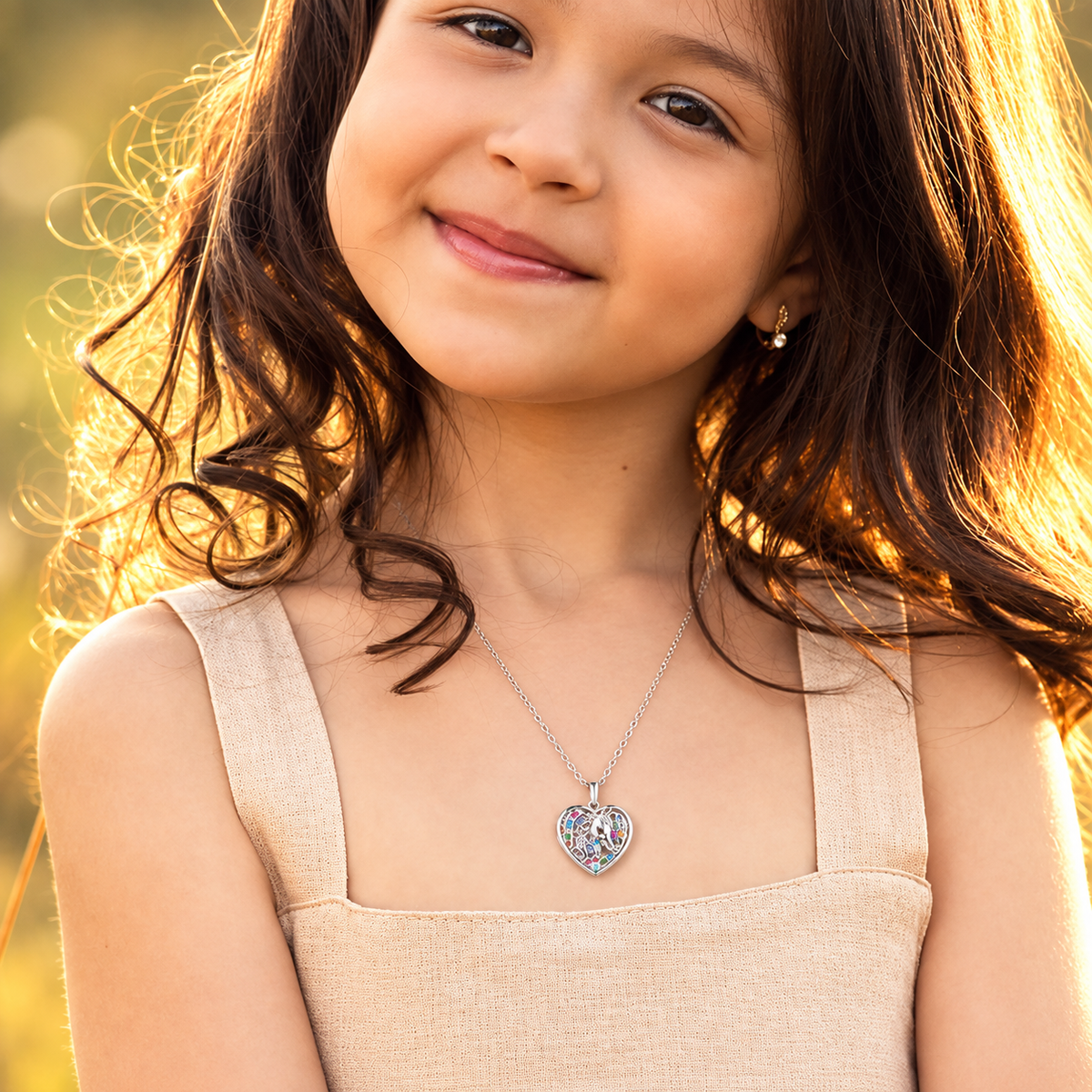 Young girl wearing a custom unicorn photo locket necklace