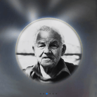 Black and white portrait of an elderly man with a thoughtful expression, framed by a circular vignette with a blurred background.