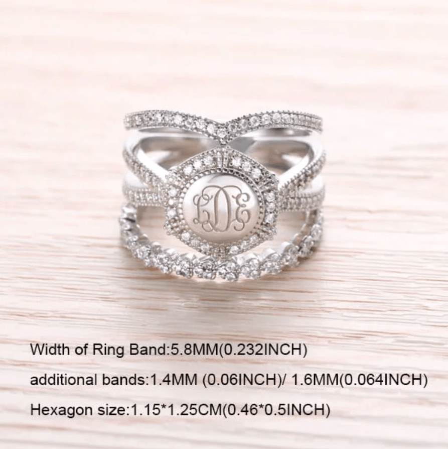 A hexagon-shaped sterling silver ring with central monogram "LDE" amidst cubic zirconias, flanked by detailed stackable bands with size specifications.