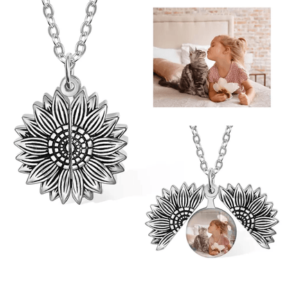 Silver sunflower pendant necklace with a locket containing a photo of a girl kissing a cat.