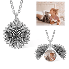 Silver sunflower pendant necklace with a locket containing a photo of a girl kissing a cat.