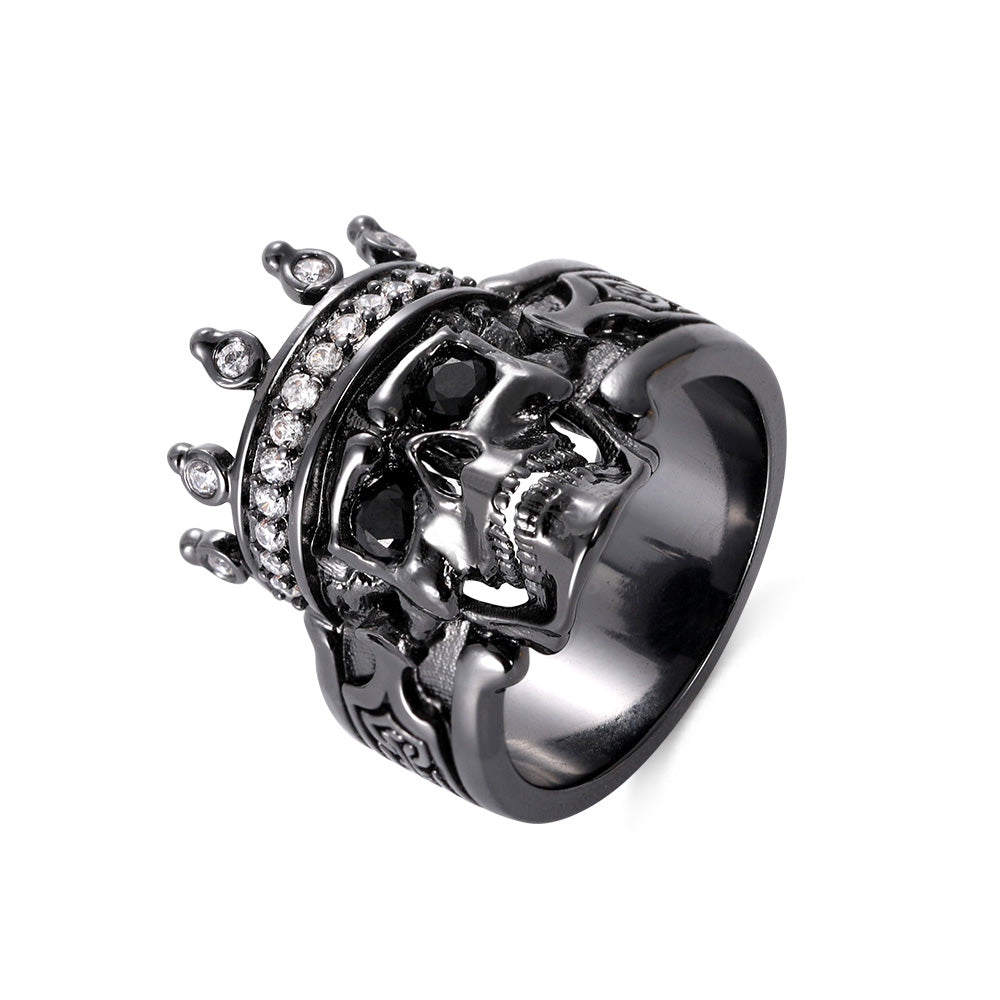 Black gothic king ring with skull, crown detailing, and encrusted with clear crystals.