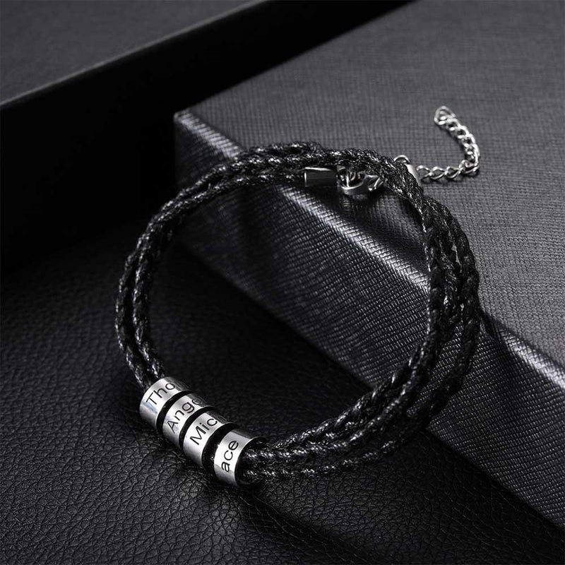 Elegant black braided bracelet with four silver beads engraved 'Thor', 'Angel', 'Michael', 'Ace', displayed on a textured black box.