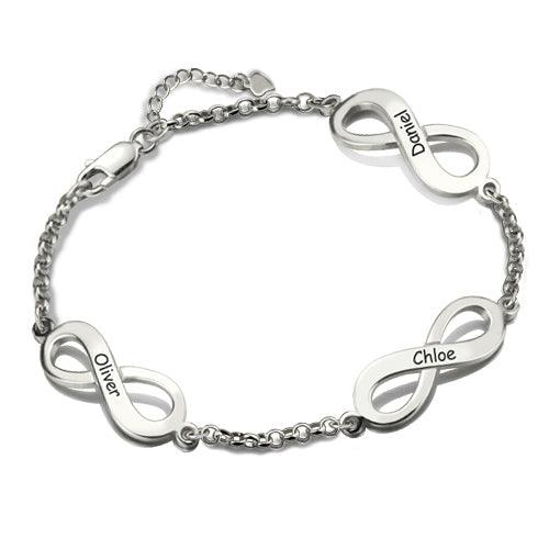 A silver bracelet with three infinity symbols, each engraved with a name: "Oliver," "Chloe," and "Daniel." The bracelet has a chain link design and a clasp.