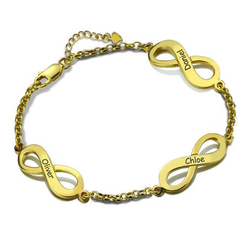 A gold bracelet with three infinity symbols, each engraved with a name: "Oliver," "Chloe," and "Daniel." The bracelet features a chain link design and a clasp.