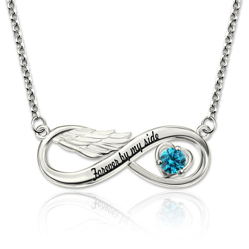 A silver infinity necklace with angel wings on the left, a blue heart-shaped gem on the right, and the inscription "Forever by my side" in the center.