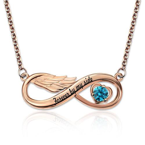 A rose gold infinity necklace with angel wings on the left, a blue heart-shaped gem on the right, and the inscription "Forever by my side" in the center.