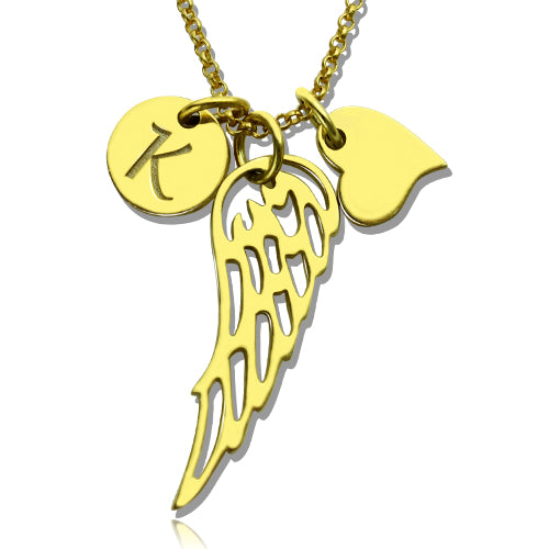 A gold necklace with three charms: a circular disc with the letter "K," an angel wing, and a heart, displayed on a white background.