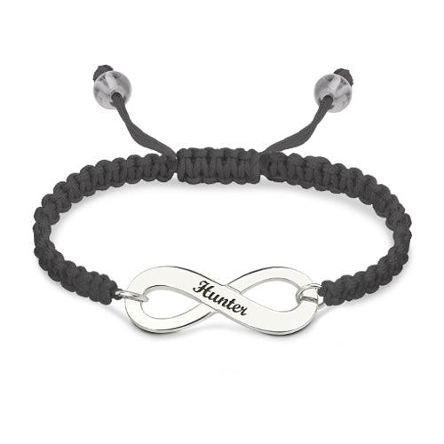 Customizable silver infinity symbol bracelet with the name 'Hunter' engraved, paired with a black braided band and adjustable closure.