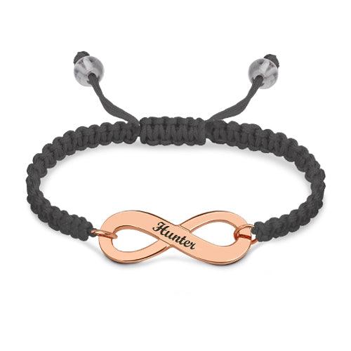 "Customizable rose gold infinity symbol bracelet with 'Hunter' engraved, on a black braided band with adjustable closure.