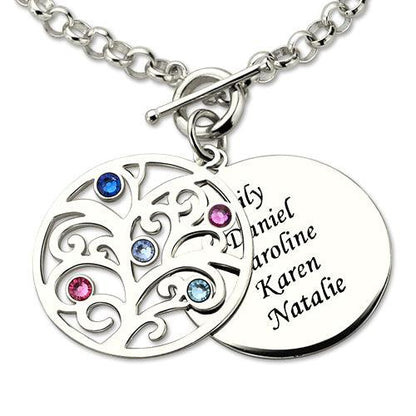 A silver charm bracelet with a toggle clasp, featuring a tree pendant with colored gemstones and a round disc engraved with the names Lily, Daniel, Caroline, Karen, and Natalie.