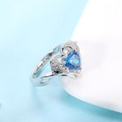 Silver angel wing ring with a heart-shaped blue gemstone and 'Always in my heart' inscription CG274-2 - 600 x 600px