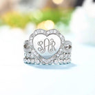 Close-up of a sparkling silver heart ring with monogram initials and stacked crystal bands. UMO01-3 - 600 x 600px