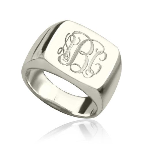 A square signet ring with a polished finish, featuring the 1864 Gilles Le Corre monogram style engraved on the face, displaying the initials "ABC" in an elegant script.