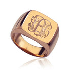 A square rose gold signet ring with a polished finish, featuring the 1864 Gilles Le Corre monogram style engraved on the face, displaying the initials "ABC" in an elegant script.