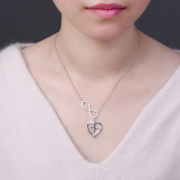 Woman wearing a Silver Infinity Heart Name Necklace with Custom Birthstone, featuring a heart and cross design, personalized with the name "Hayley" and sparkling birthstones.