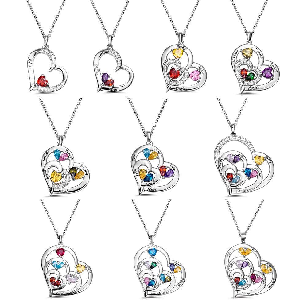  collection of heart-shaped pendants with colorful gemstones, each engraved with different names, displayed in three rows of three pendants each, on silver chains.